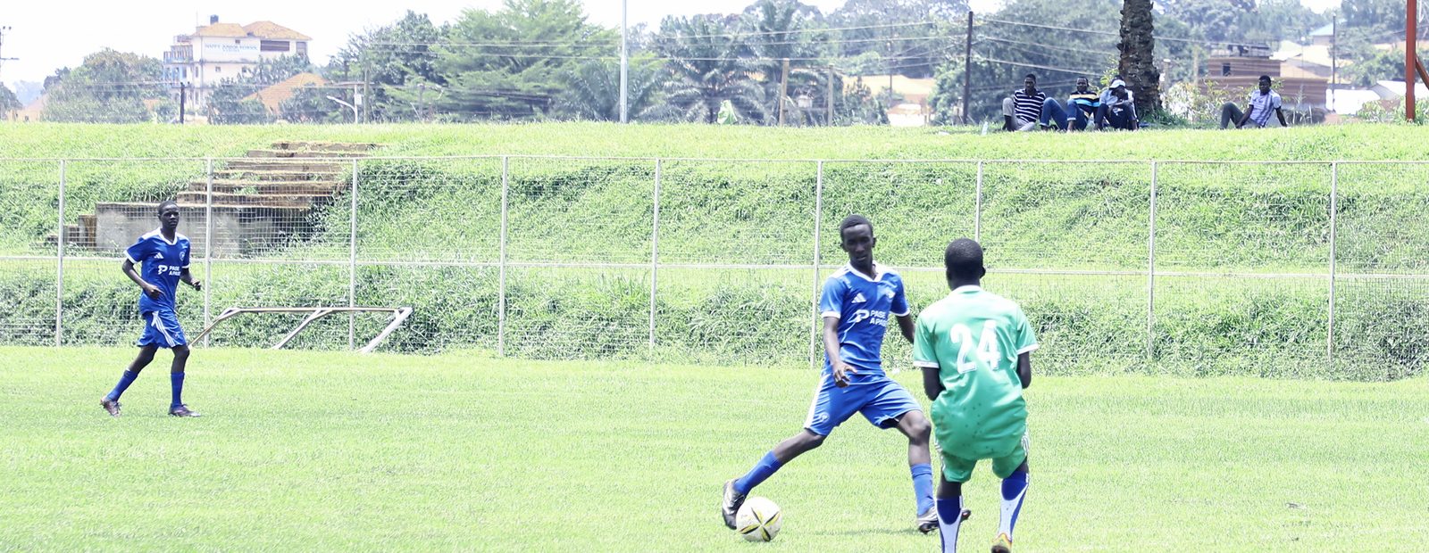 Play in progress at Mutesa II Stadium, Wankulukuku, the ground sign visible behind the pitch