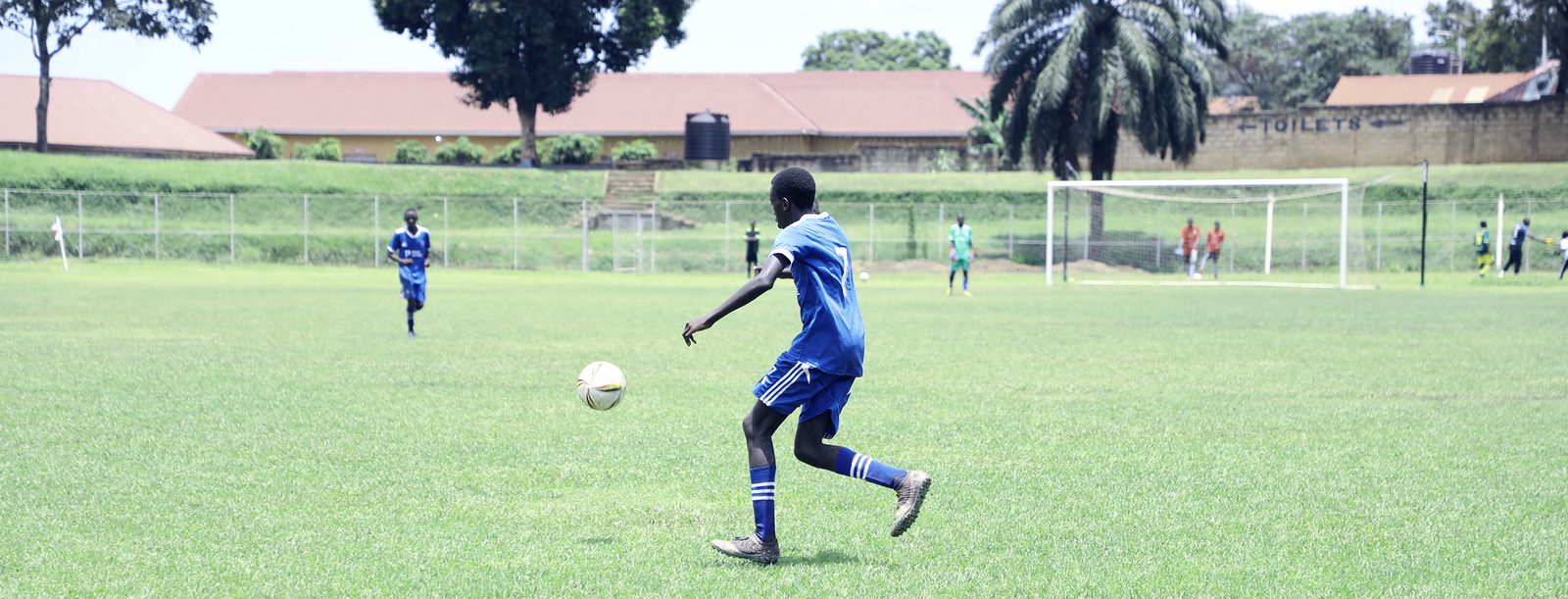 A PASE A PASE player strikes the ball across an open pitch during a match